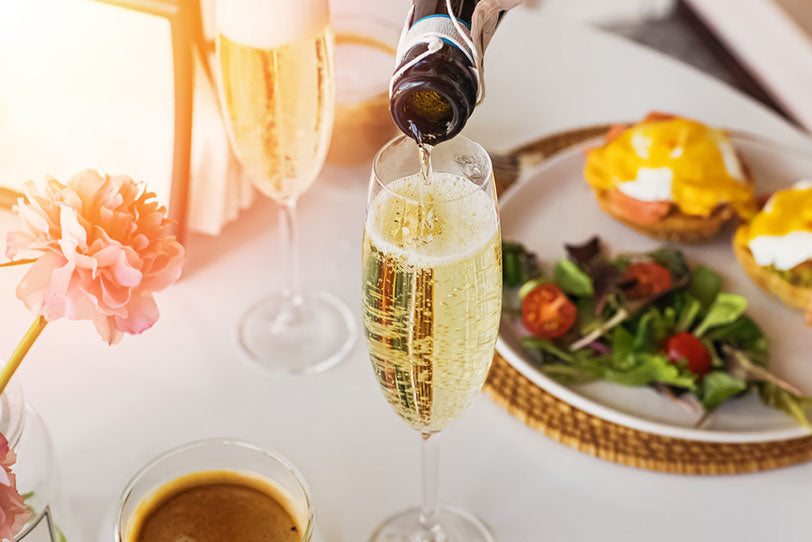 pouring bubbly wine into glass
