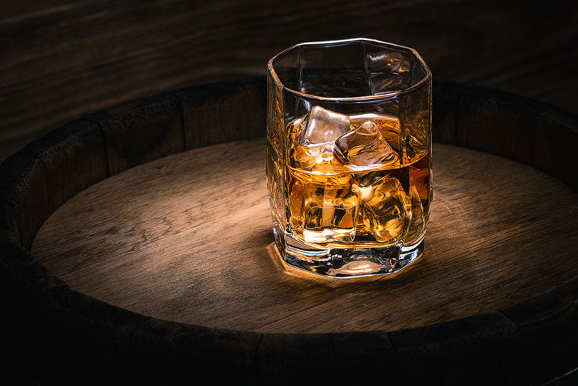 whiskey glass with ice on table