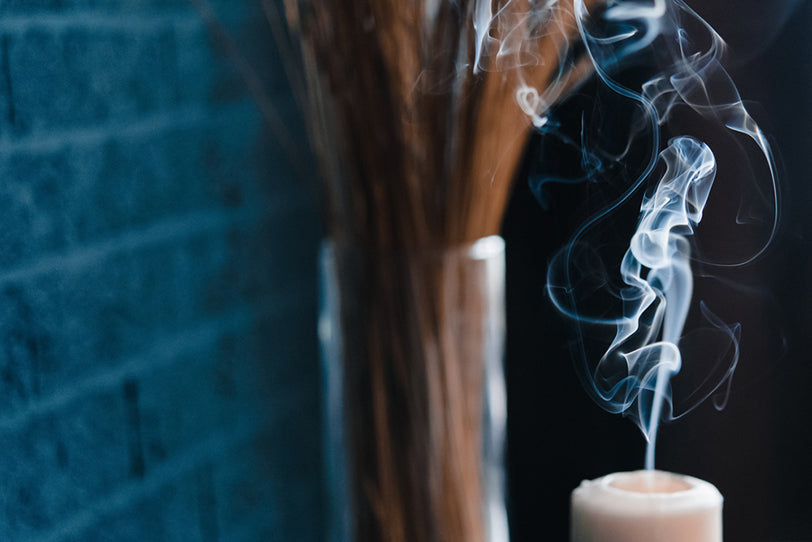 a picture of smoke rising from an extinguished candle
