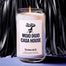 A closeup of the Mojo Dojo Casa House candle in front of a black fringe leather background.