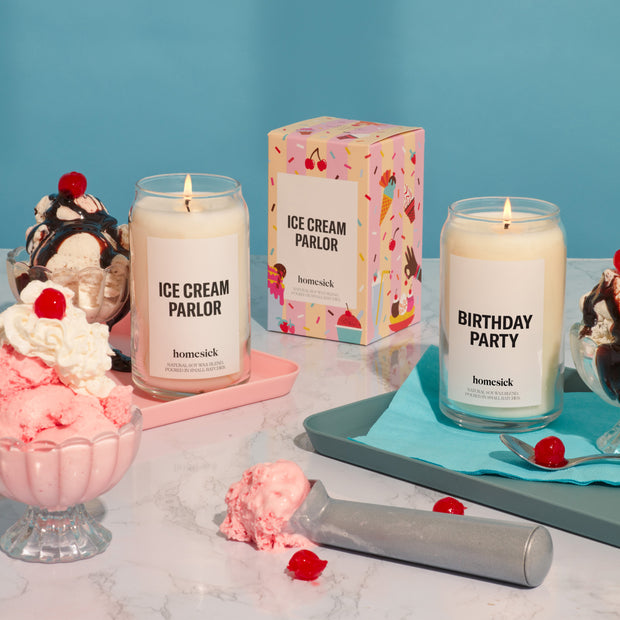 A playful display of the Ice Cream and Birthday Party homesick candles. There are ice cream props all around for the celebratory shot.
