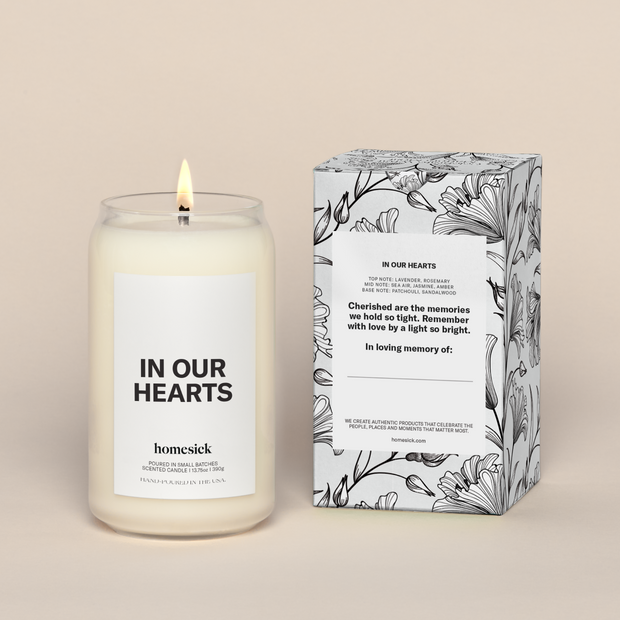 On the left is a lit In Our Hearts Candle and to the right is the packaging. The packaging shows the information on the back label.