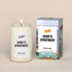 A lit Jerry's Apartment Homesick candle displayed next to its boxed packaging on a dark cream background.