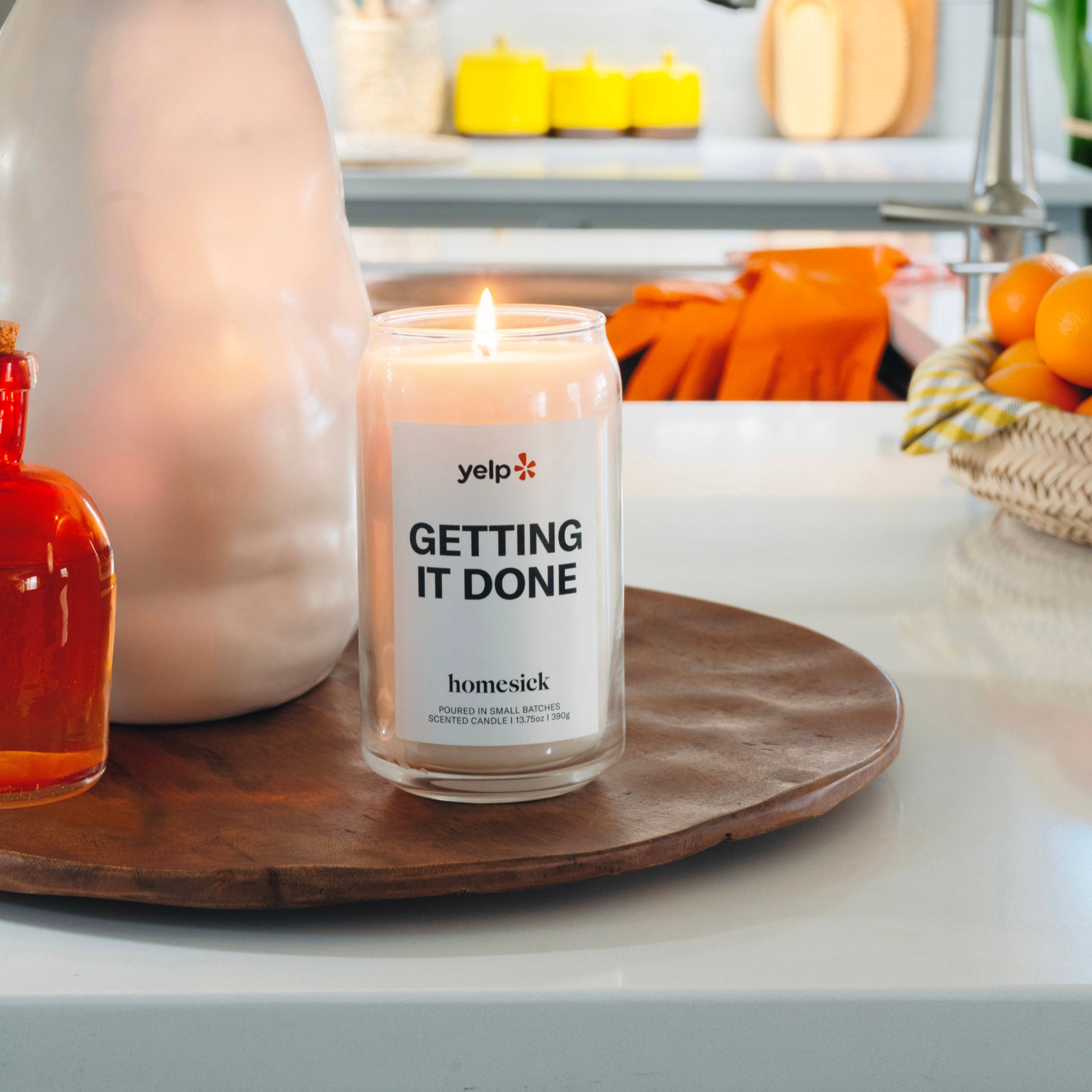 A lit Getting It Done candle in a clean environment