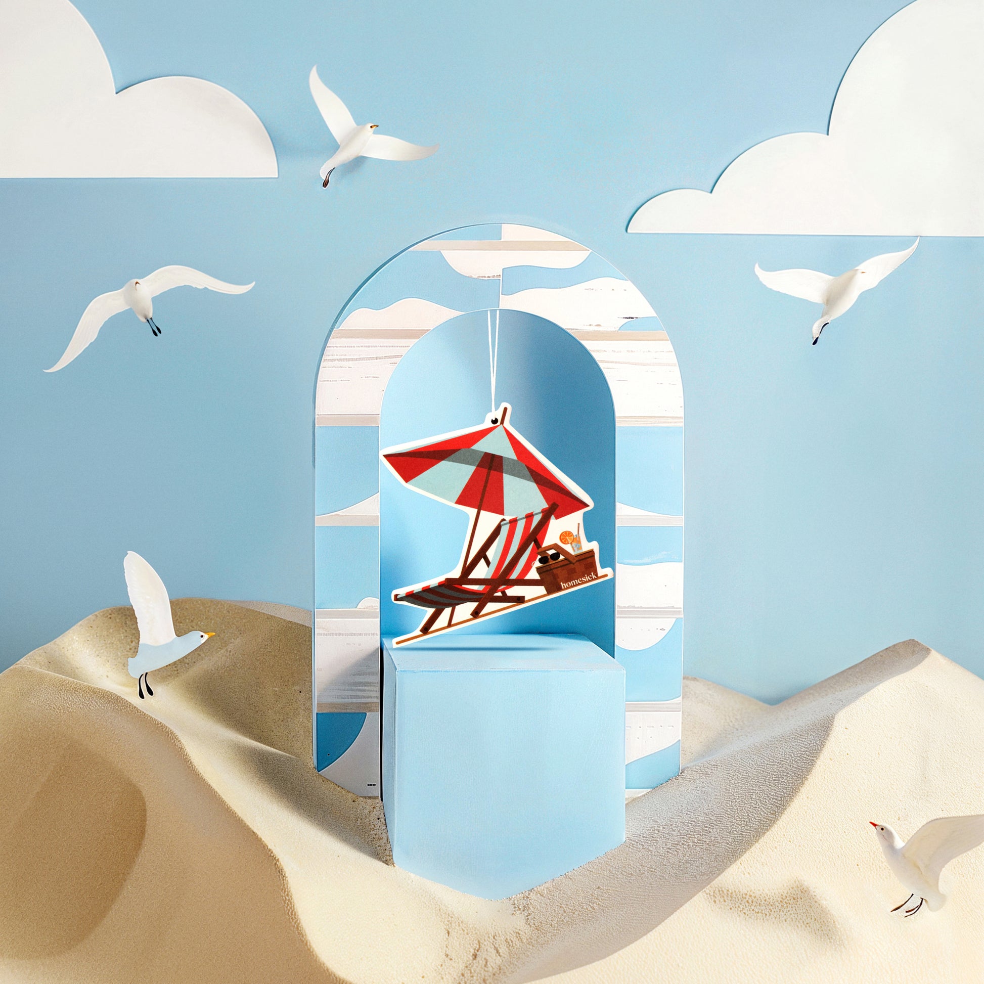 Lifestyle image of car freshener in a stylized beach scene