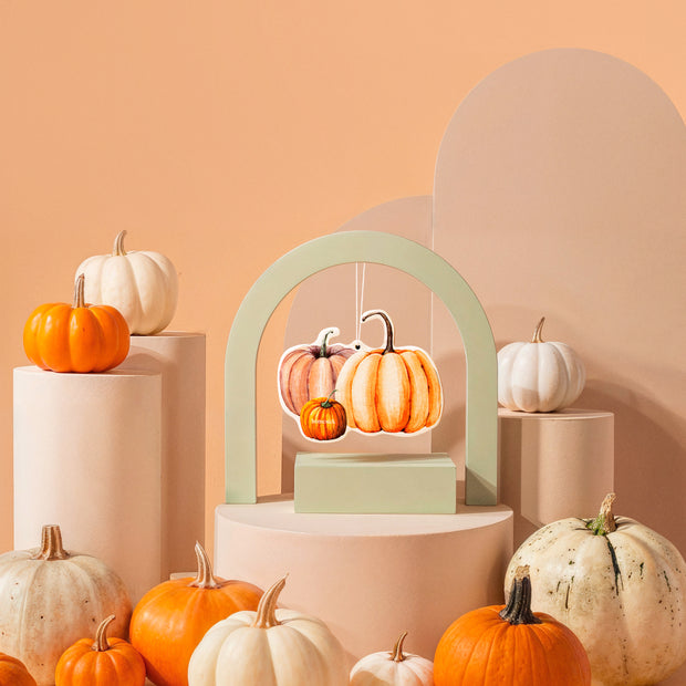 Car freshener on a stylized background with various pumpkins