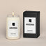 A lit Arizona Homesick candle displayed next to its boxed packaging on a dark cream background.