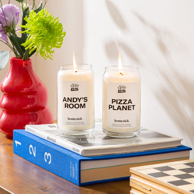 The Andy's Room and Pizza Planet Candle displayed on a two stacked books in a nicely decorating living room.