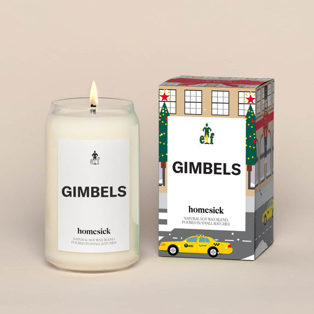 A lit Gimbels Homesick candle displayed next to its boxed packaging on a dark cream background.