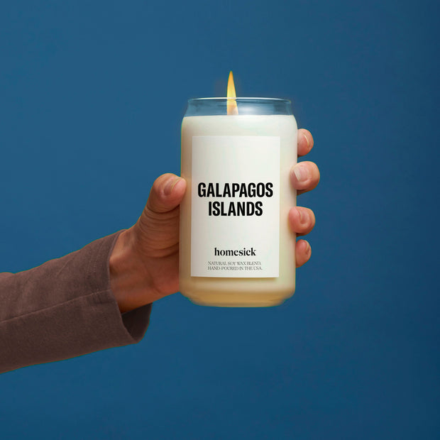 A hand holding the Galapagos Islands candle.