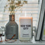 Lit New York City candles sitting on a cozy window sill.
