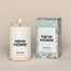 New Home Candle next to the packaging. Packing is a soft blue box with animated overall print of different homes.