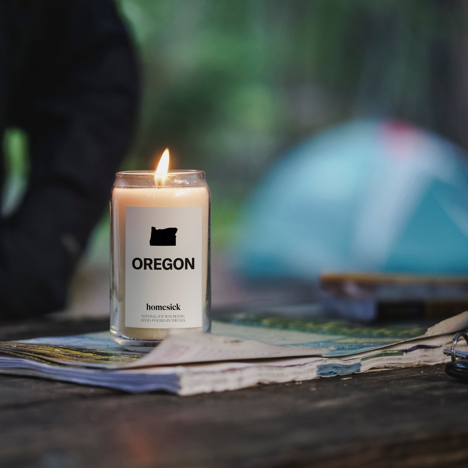 A close up of the Oregon candle that is displayed on top of old newspaper. The background is blurred. 