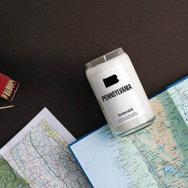 An overhead shot of the Pennsylvania candle that is overlayed on road maps. 