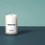 A Seattle Homesick candle displayed on top of a deep blue surface and mint green background.