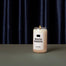 The South Dakota candle on a dark gray surface with a navy silk curtain as the background.
