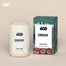 A Endor Homesick candle displayed next to its boxed packaging on a dark cream background.