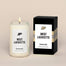 A lit West Lafayette Homesick candle displayed next to its boxed packaging on a dark cream background.